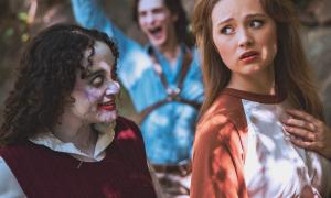 A woman reacting to a possessed friend approaching her