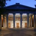 Fine Arts Building in early evening: columned building with three wooden doors and murals depicting the arts above the doors